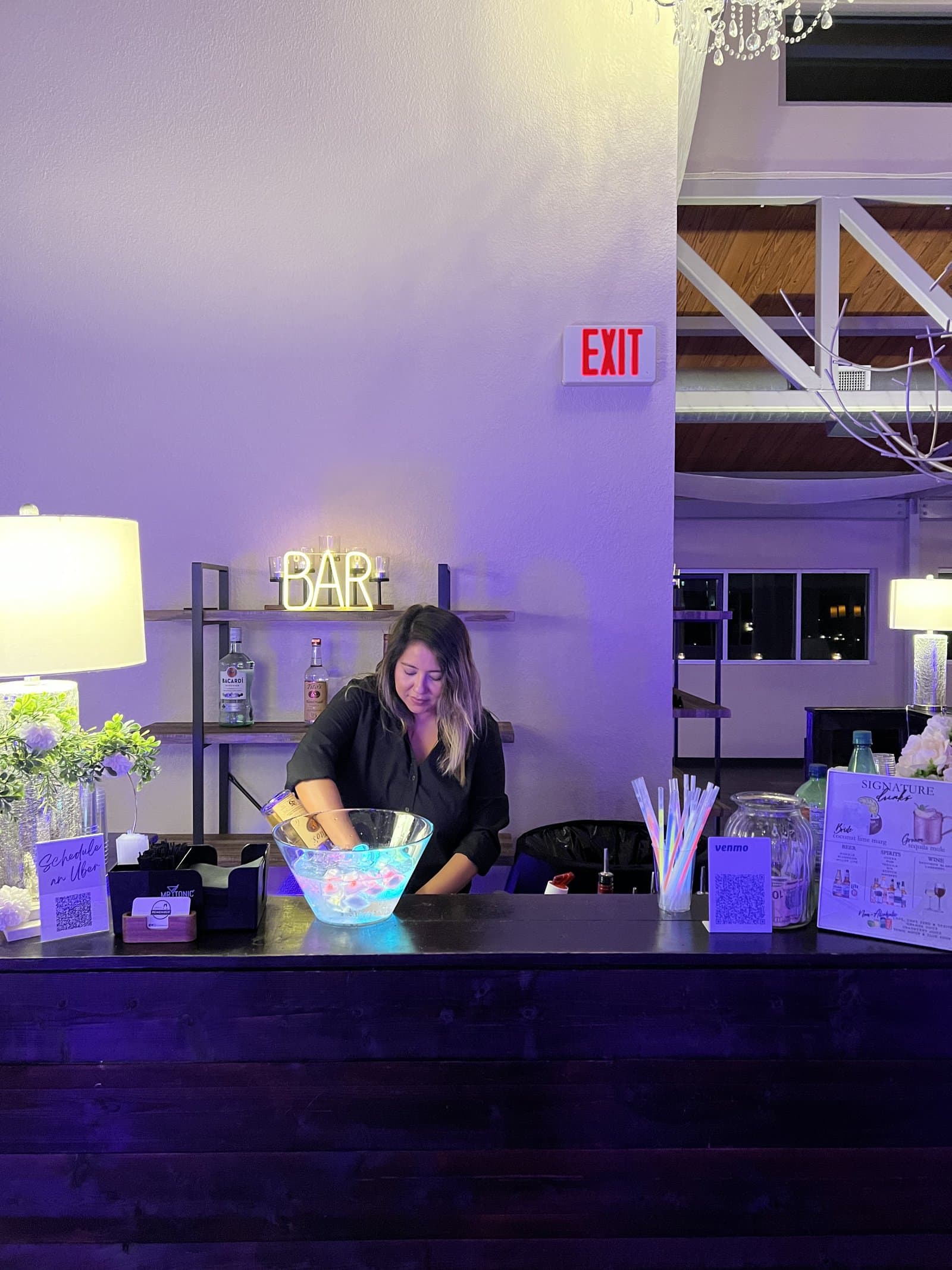 Bartender at wedding with purple lights