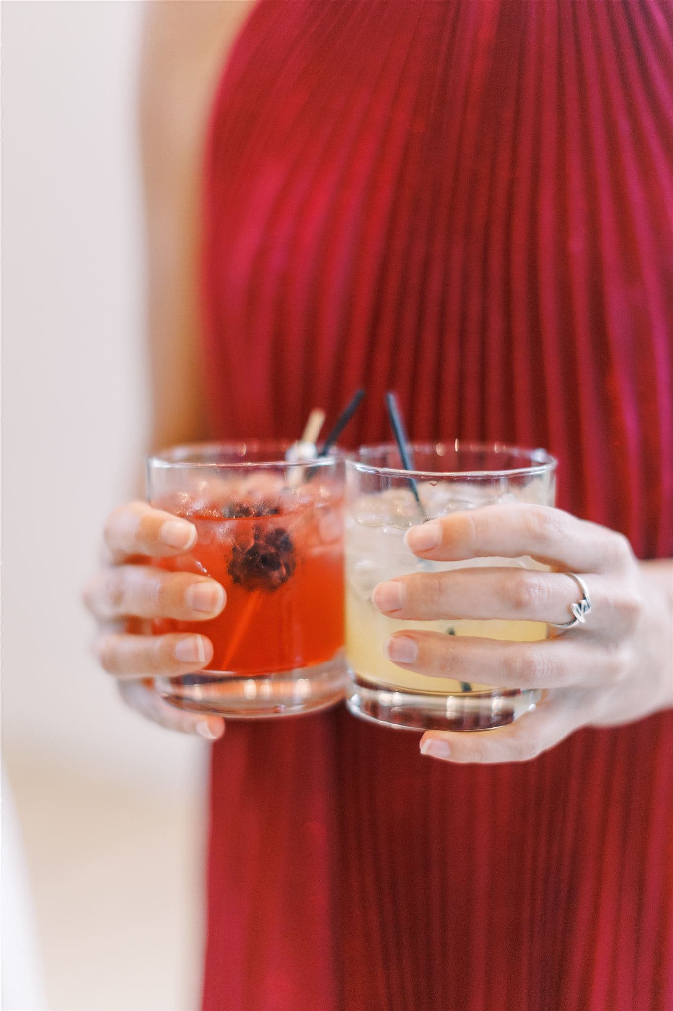 Guest holding two craft cocktails