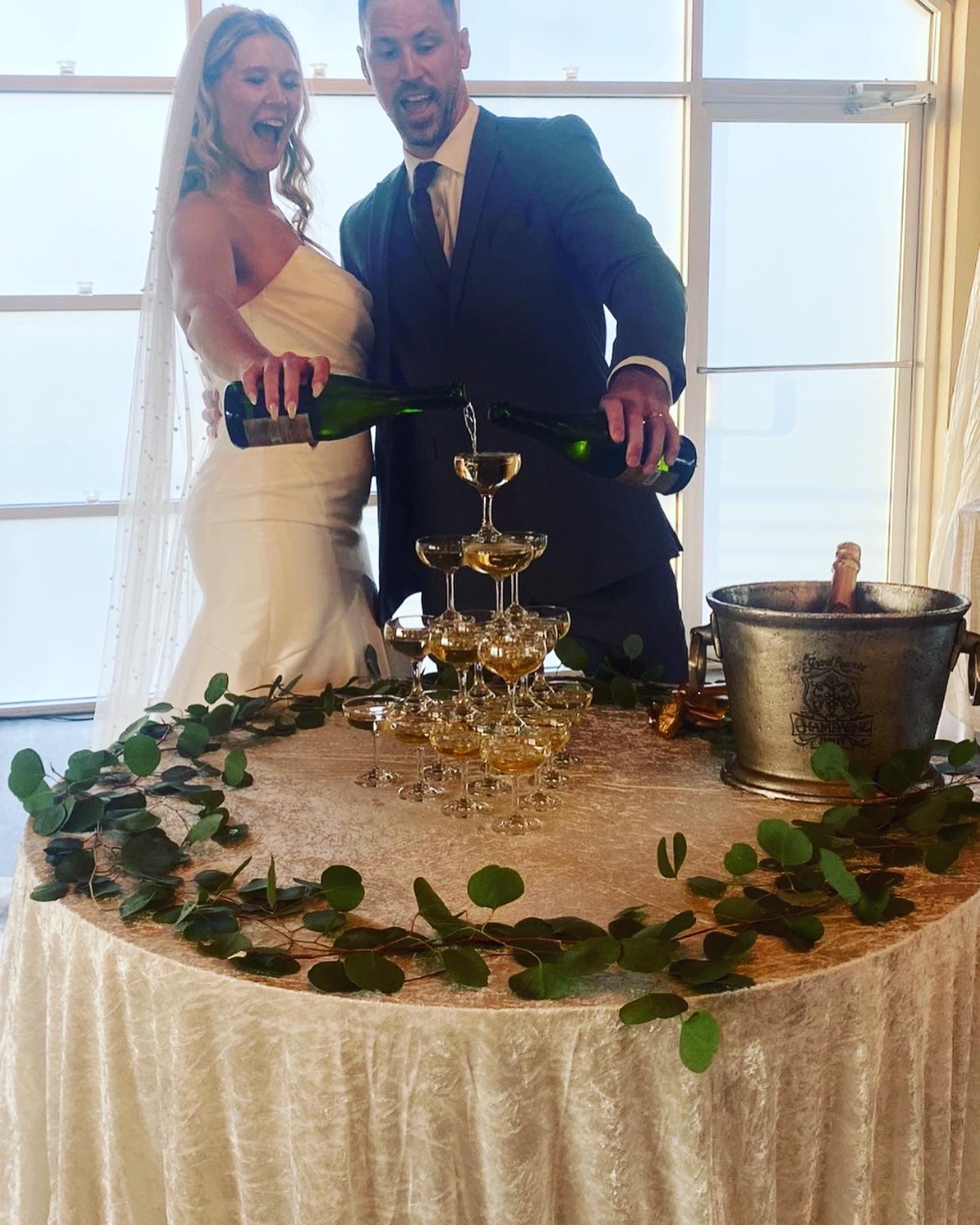 Bride and groom pouring champagne tower