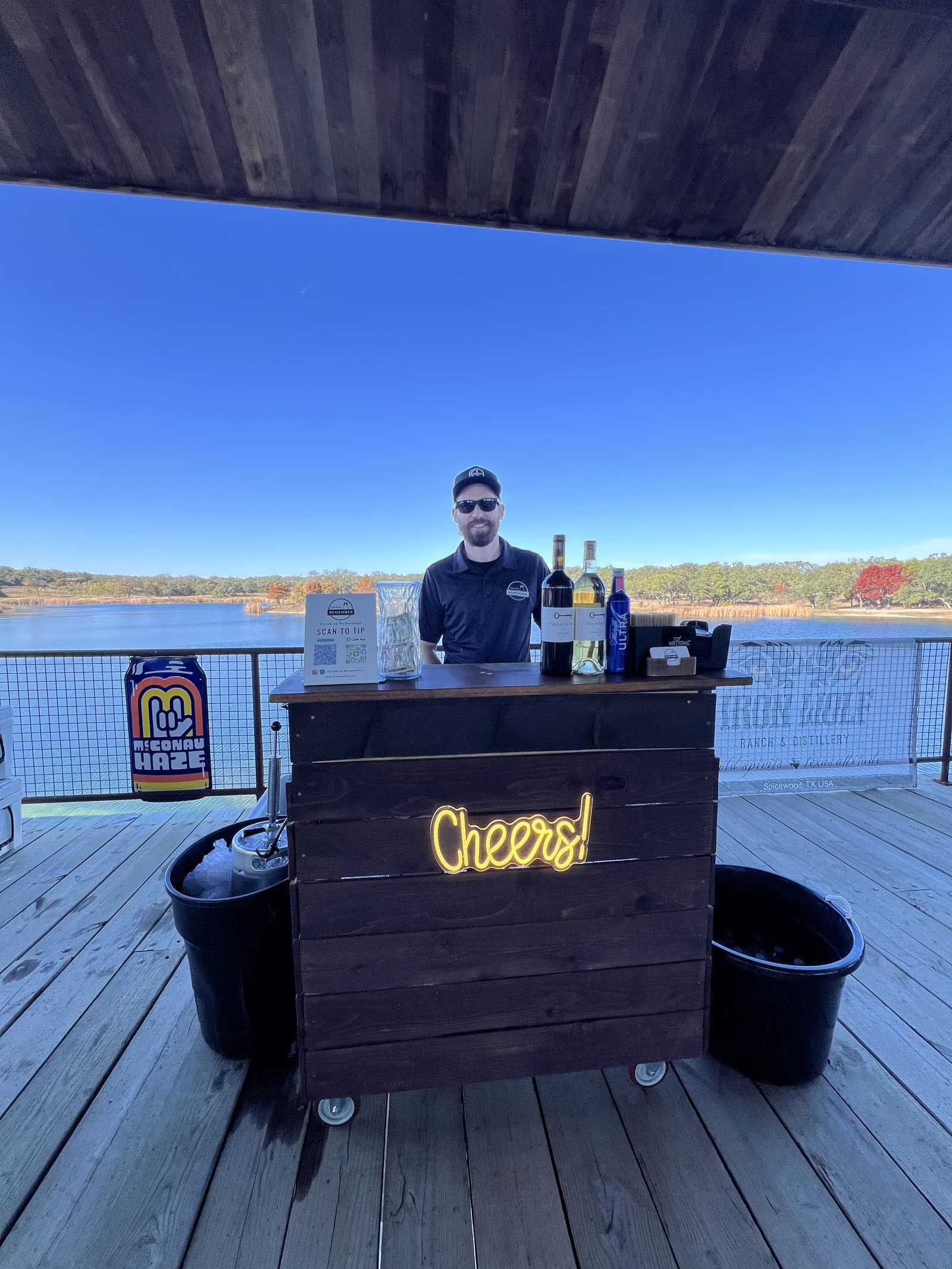 Bartender serving on a lakeside dock